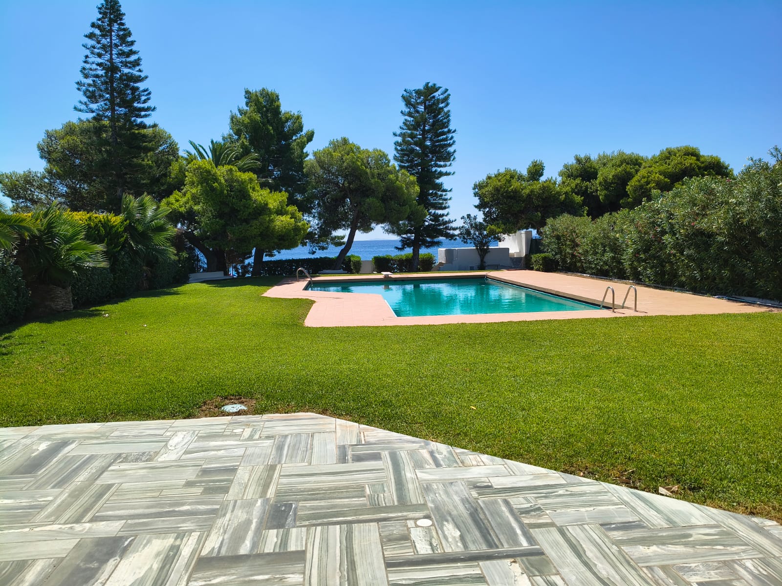 Aerial view of the pool, garden and sea